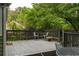 Outdoor deck with table and chairs nestled among lush greenery at 1682 Grace Se St, Atlanta, GA 30316
