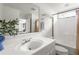 Bathroom with white vanity, toilet, and tub/shower combo, accented with gold hardware and decorative accessories at 1682 Grace Se St, Atlanta, GA 30316