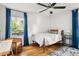 Cozy bedroom with hardwood floors, a ceiling fan, and a window offering natural light and an outdoor view at 1682 Grace Se St, Atlanta, GA 30316