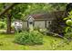 Charming home with green siding surrounded by lush, mature plants, providing a serene setting at 1682 Grace Se St, Atlanta, GA 30316