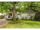 Charming home featuring green siding, a covered porch, and a lush, mature tree in the front yard at 1682 Grace Se St, Atlanta, GA 30316