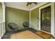 Cozy front porch featuring comfortable seating and a welcoming 