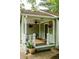 Inviting covered porch with hanging flower baskets and comfortable seating, enhancing curb appeal at 1682 Grace Se St, Atlanta, GA 30316