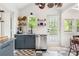 Bright, modern kitchen with stainless steel appliances, granite countertops, floating shelves, and a charming checkerboard floor at 1682 Grace Se St, Atlanta, GA 30316