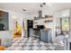 Well-equipped kitchen with stainless steel appliances and floating shelves leading to a cozy living space and bedroom at 1682 Grace Se St, Atlanta, GA 30316