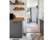 Tastefully designed kitchen with granite countertops and floating shelves leading to a serene bedroom at 1682 Grace Se St, Atlanta, GA 30316