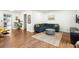 Cozy living room featuring hardwood floors, a stylish sectional sofa, and a decorative rug creating a warm atmosphere at 1682 Grace Se St, Atlanta, GA 30316