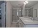 Bathroom featuring dual sinks, white cabinets, and a glass enclosed shower at 204 Mahnaz Dr, Atlanta, GA 30331