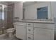 Bathroom featuring dual sinks, white cabinets, and a glass enclosed shower at 204 Mahnaz Dr, Atlanta, GA 30331