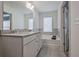 Bathroom featuring dual sinks, white cabinets, a bathtub, and lots of light at 204 Mahnaz Dr, Atlanta, GA 30331