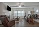 Living room with a fireplace, large windows, and comfortable leather seating arrangement at 204 Mahnaz Dr, Atlanta, GA 30331