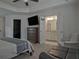 Primary bedroom with a tv, dresser and ensuite bathroom with double doors at 204 Mahnaz Dr, Atlanta, GA 30331