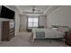 A spacious primary bedroom with a large bed, tv, ceiling fan, and windows at 204 Mahnaz Dr, Atlanta, GA 30331