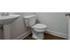 Cozy powder room featuring white fixtures, wood floors, and fresh, neutral paint tones at 204 Mahnaz Dr, Atlanta, GA 30331