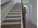 A wooden staircase with a white risers and dark wood treads at 204 Mahnaz Dr, Atlanta, GA 30331