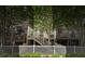 View of the townhome featuring a wooden deck, staircase and white picket fence lined with well manicured bushes at 291 Goodson Nw Way, Atlanta, GA 30309