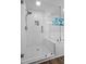 Bright bathroom featuring a glass enclosed shower with white subway tile, and white herringbone tile floor at 291 Goodson Nw Way, Atlanta, GA 30309