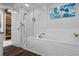 Bathroom features a large tub, glass-enclosed shower, and storage at 291 Goodson Nw Way, Atlanta, GA 30309