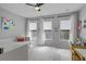 Bright bedroom with three windows, neutral walls, a ceiling fan, and carpeted floor at 291 Goodson Nw Way, Atlanta, GA 30309