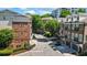 Aerial view of townhome community showing the brick exteriors, manicured landscaping, and community sign at 291 Goodson Nw Way, Atlanta, GA 30309
