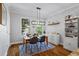 Bright dining room featuring a modern light fixture, shelving unit, and light-colored walls at 291 Goodson Nw Way, Atlanta, GA 30309