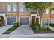 Townhome exterior showcases a private garage, manicured lawn, and inviting front entry at 291 Goodson Nw Way, Atlanta, GA 30309
