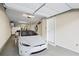 Clean garage featuring a Tesla car, ample storage, and bright overhead lighting at 291 Goodson Nw Way, Atlanta, GA 30309