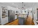 Open kitchen features stainless appliances, island, and access to dining area at 291 Goodson Nw Way, Atlanta, GA 30309