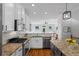Open-concept kitchen features granite countertops, stainless appliances, and a breakfast bar at 291 Goodson Nw Way, Atlanta, GA 30309