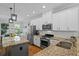 Bright kitchen with white cabinets, granite countertops, and stainless steel appliances at 291 Goodson Nw Way, Atlanta, GA 30309