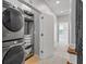 The laundry room features a stackable washer-dryer with shelving and a herringbone accent wall at 291 Goodson Nw Way, Atlanta, GA 30309