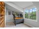 Sunlit office with a desk, chair, shelving unit, and large windows overlooking lush greenery at 291 Goodson Nw Way, Atlanta, GA 30309