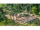 Aerial view of a playground featuring multiple play structures and picnic tables nestled among mature trees at 291 Goodson Nw Way, Atlanta, GA 30309