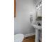 Stylish powder room featuring a pedestal sink, modern fixtures, and light gray walls at 291 Goodson Nw Way, Atlanta, GA 30309
