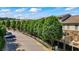 Street view of townhomes featuring well-manicured green trees, landscaped grounds, and guest parking spots at 291 Goodson Nw Way, Atlanta, GA 30309