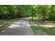 A paved walking path winds through a lush green park lined with trees, offering a serene outdoor experience at 291 Goodson Nw Way, Atlanta, GA 30309