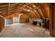 Large attic space with exposed wooden beams, insulation, and a window at 4530 Upland Court, Cumming, GA 30040