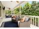 Covered back porch with seating, creating a relaxing outdoor living area with a view at 4530 Upland Court, Cumming, GA 30040
