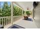 Inviting back porch with comfortable seating and privacy from mature trees in a backyard oasis at 4530 Upland Court, Cumming, GA 30040