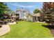 Beautifully landscaped backyard featuring a stone patio, expansive lawn, and charming exterior details at 4530 Upland Court, Cumming, GA 30040