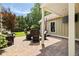 Backyard patio with outdoor seating, a mounted TV, and a well-manicured lawn, ideal for outdoor entertainment at 4530 Upland Court, Cumming, GA 30040