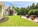 Backyard patio with outdoor furniture and lush green lawn surrounded by mature landscaping at 4530 Upland Court, Cumming, GA 30040