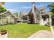 Sprawling backyard featuring green lawn, patio seating, and a charming home at 4530 Upland Court, Cumming, GA 30040