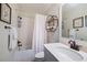 Cozy bathroom with a modern sink, vanity, framed pictures, and tub with shower at 4530 Upland Court, Cumming, GA 30040