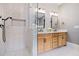 Modern bathroom showcasing a glass shower, herringbone tile, and light wood double vanity at 4530 Upland Court, Cumming, GA 30040