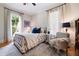 Comfortable bedroom with a bed, a chair, and large windows with lots of natural light overlooking a beautiful yard at 4530 Upland Court, Cumming, GA 30040