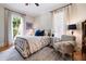 Bright bedroom featuring a large window, comfortable chair, and stylish decor at 4530 Upland Court, Cumming, GA 30040