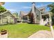 Exterior shot of a home with a green lawn, a covered patio and a stone walkway leading to backyard features at 4530 Upland Court, Cumming, GA 30040