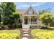 Charming home featuring a welcoming front porch with ceiling fans and landscaped front yard at 4530 Upland Court, Cumming, GA 30040