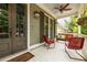 Inviting front porch with cozy seating, ceiling fan, and hanging flower baskets at 4530 Upland Court, Cumming, GA 30040